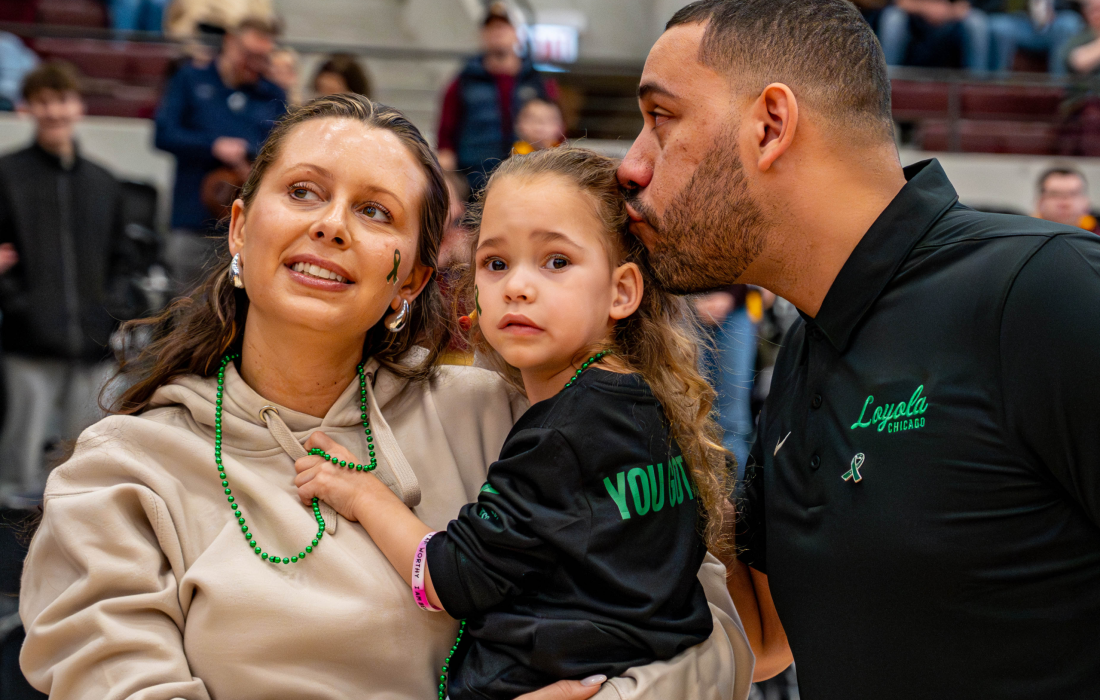Taylor (left), Hayden and Drew Valentine during the cerebral palsy awareness game Feb. 28. (Courtesy of Loyola Athletics)