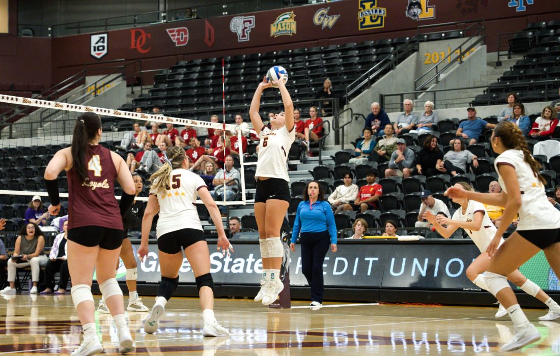 First-year setter Ava Hunter hits a set over the net against Stephen F. Austin University. (Alexis Bullard | The Phoenix)