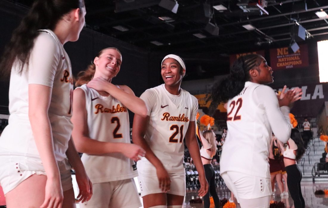 Bessette (left), Kinas and Vaughn smile during starting lineup announcements. (Andi Revesz | The Phoenix)