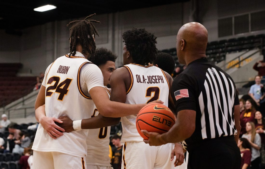 The Ramblers huddle before the ball enters play. (Bella Adams | The Phoenix)