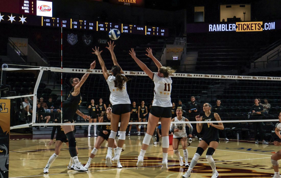 Second-year outside hitter Leyna Nguyen and third-year middle blocker Chloe Morgan jump for a block. (Dylan Eckhardt | The Phoenix)