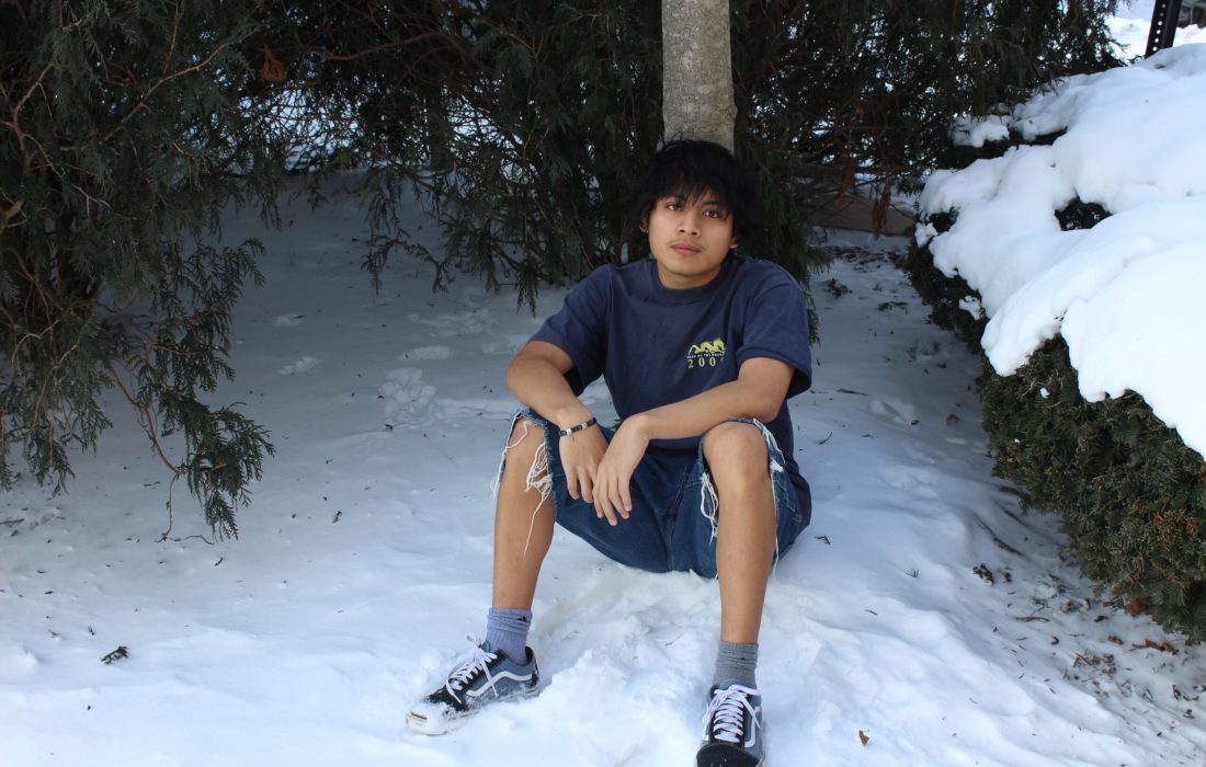 Kevin Stovich sits in snow in signature shorts (Ethan Vogeler | The Phoenix)