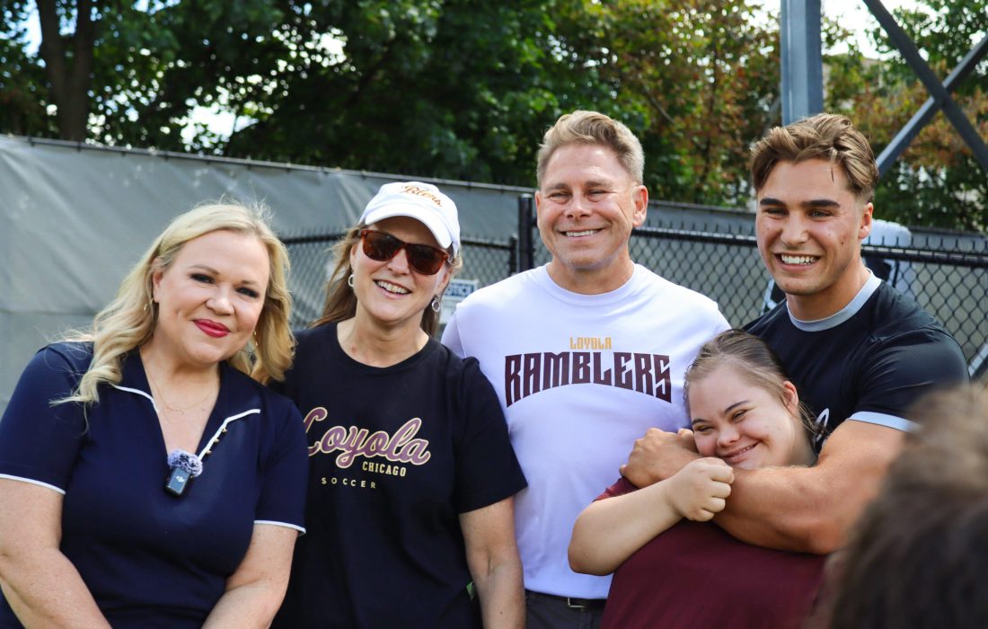 Crawford (right) with ESPN's Holly Rowe (left) and his family following his surprise ceremony. (Andi Revesz | The Phoenix)