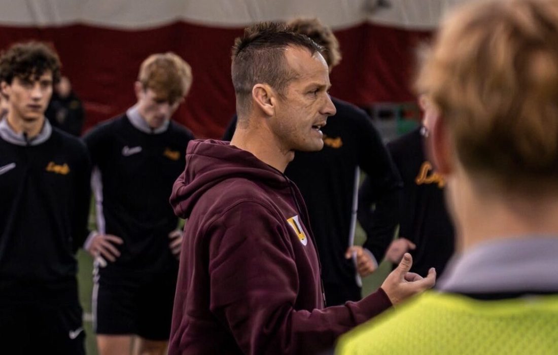 Robson talks with the men's soccer team. (Courtesy of Loyola Athletics)