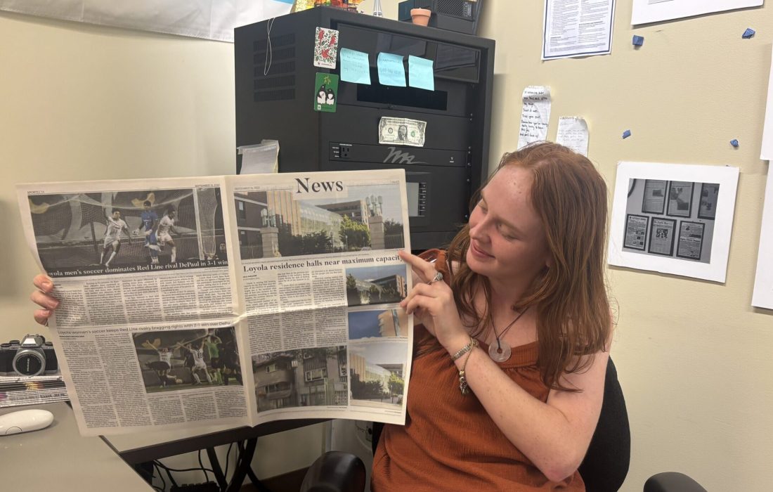 Lilli Malone, 22, holds up her first article written for The Loyola Phoenix. (Julia Pentasuglio | The Phoenix)