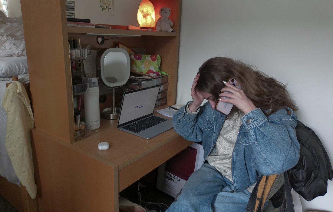 Loyola freshman education major, Charlotte Cook takes a phone call in her dorm room. (Kate Wittung | The Phoenix)