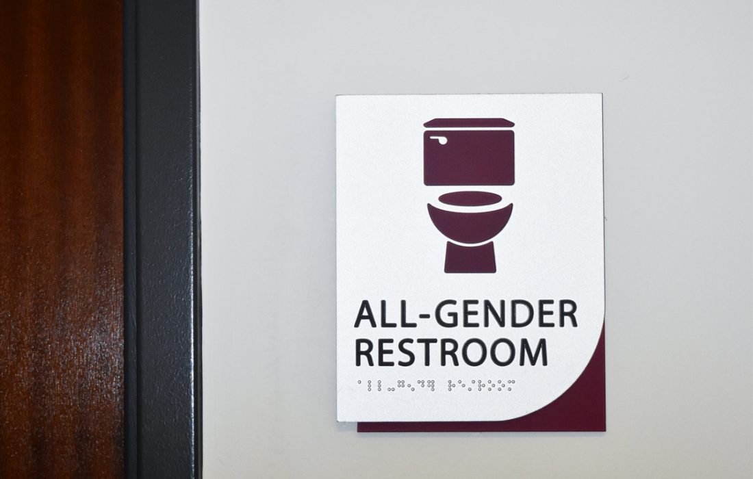 A sign labels one of Loyola's all-gender bathrooms in Cuneo Hall on on Lake Shore Campus. (Kayla Tanada | The Phoenix)