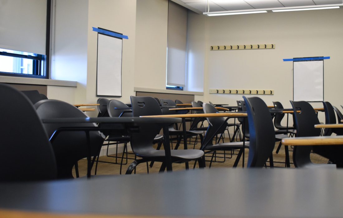 All of the desks and chairs are empty in a classroom Mundelein Hall. (Kayla Tanada | The Phoenix)
