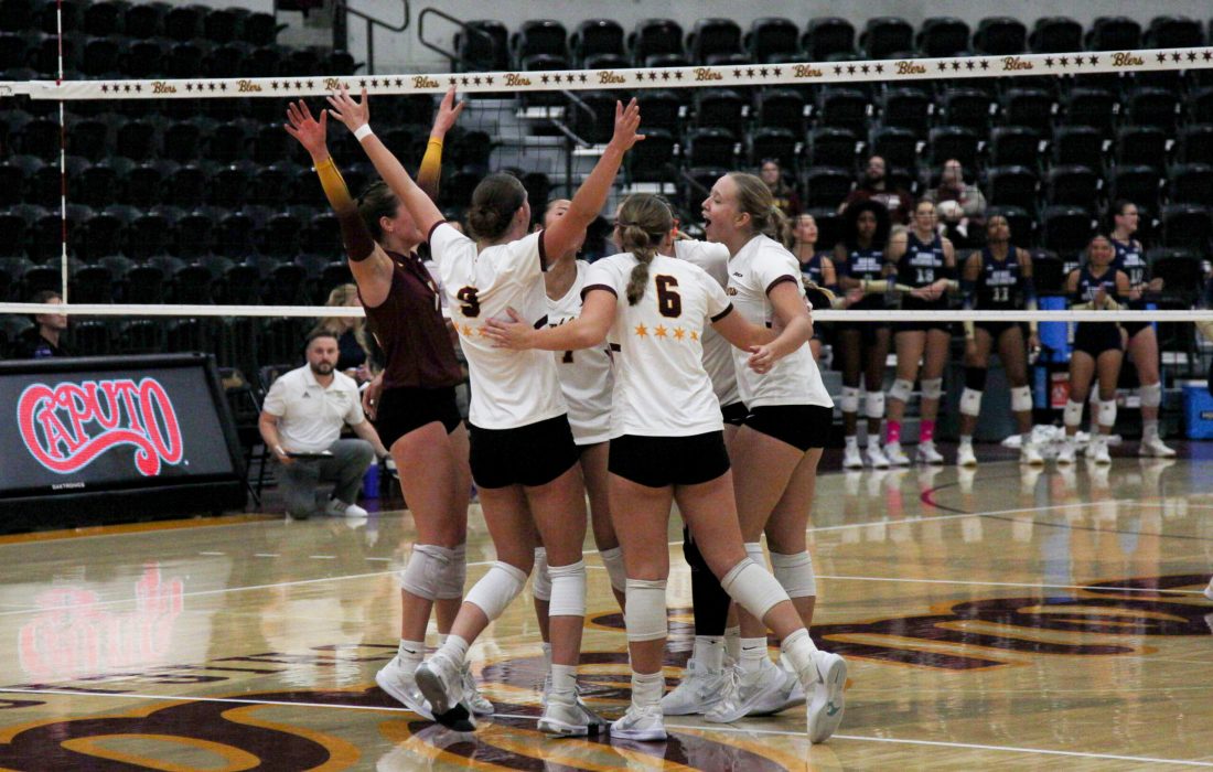 The Ramblers celebrate on the court after winning a point. (Lilli Malone | The Phoenix)