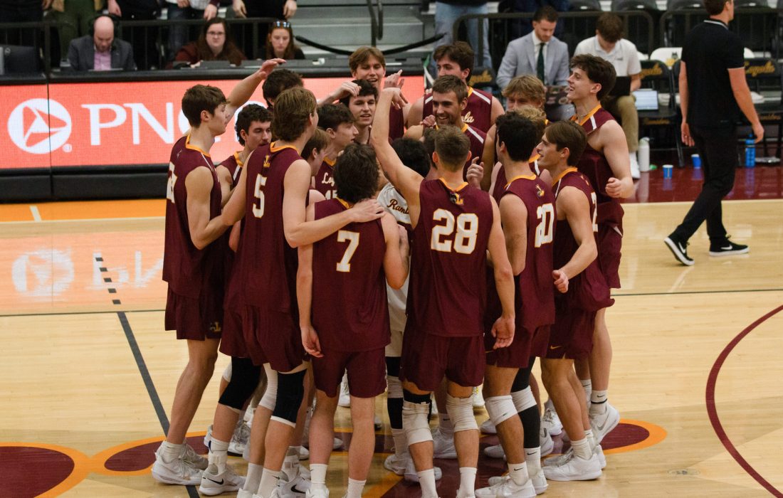 The Ramblers celebrate a sweep over Rockhurst Feb. 14. (Megan Dunn | The Phoenix)