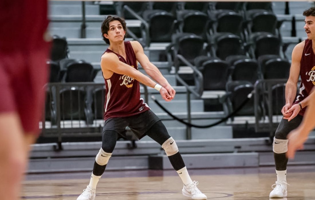 JJ Sowa bumps during warm ups. (Megan Dunn | The Phoenix)