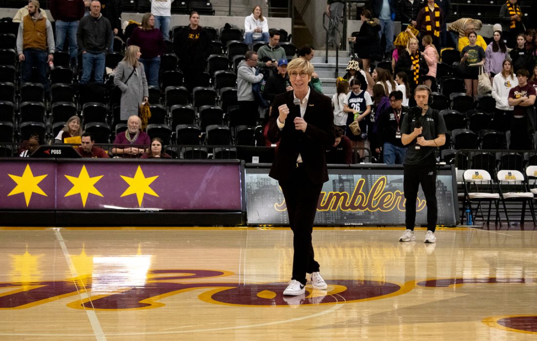 Women's basketball head coach Allison Guth thanks the crowd after games. (Megan Dunn | The Phoenix)