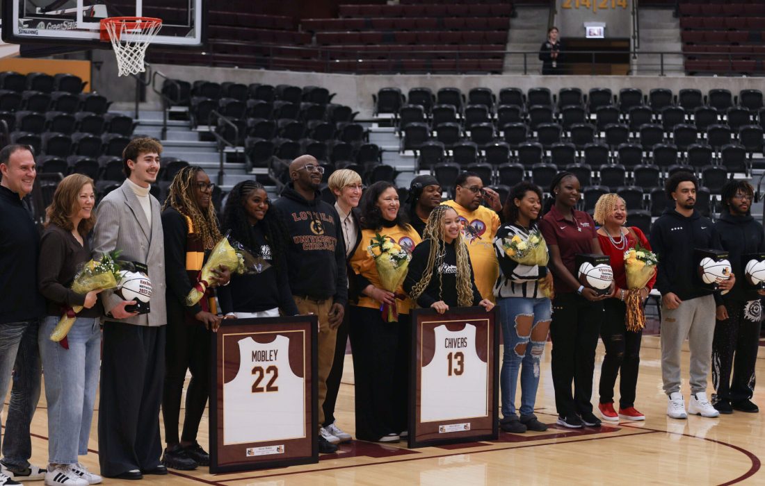 Graduate guard Alexus Mobley and fourth-year guard Kira Chivers pose with head coach Allison Guth and their families. (Norman Tiedemann | The Phoenix)