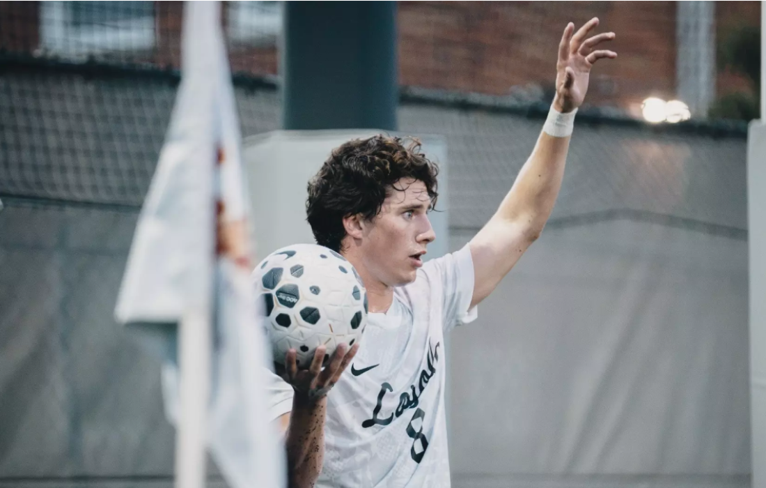 Fifth-year midfielder Seth Stewart prepping to throw the ball in. (Courtesy of Loyola Athletics)