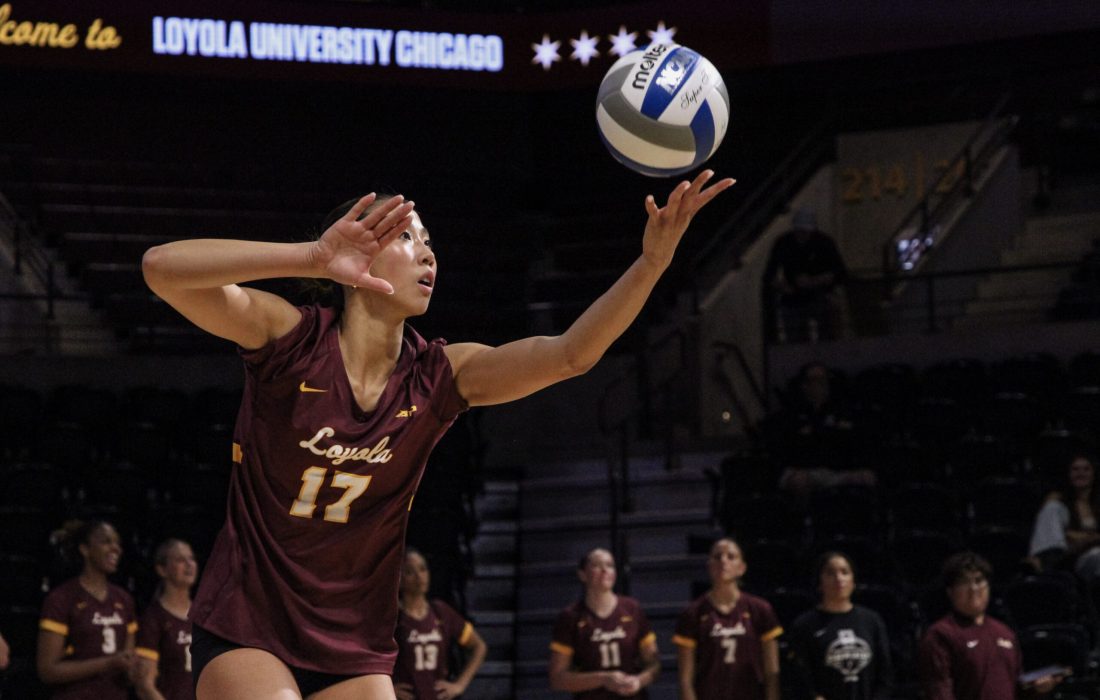 Second-year outside hitter and defensive specialist Leyna Nguyen throwing a serve. (Sophia Reass | Loyola Phoenix)