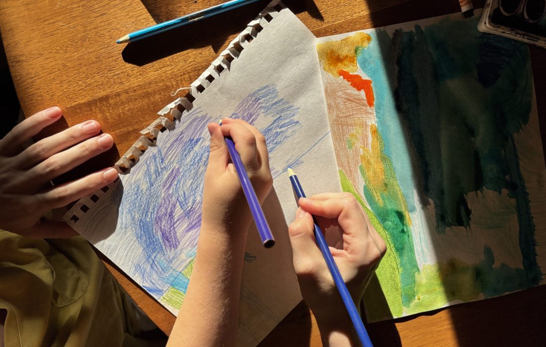 Stasia Holmes and her son draw a blue sky. (Stasia Holmes | The Phoenix)