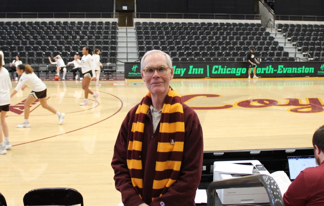 Superfan Jerry Bjurman poses by the court he has watched Loyola play on for over a decade. (Julia Pentasuglio | The Phoenix)