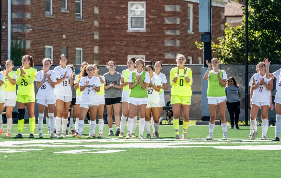 Women's soccer lines up at the end of a game. (Courtesy of Loyola Athletics)