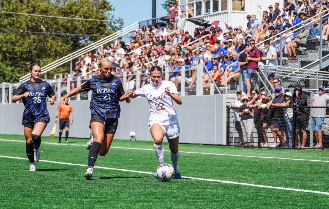 Fourth-year forward and midfielder Zoe Hevey fights off DePaul defenders. (Courtesy of Loyola Athletics)