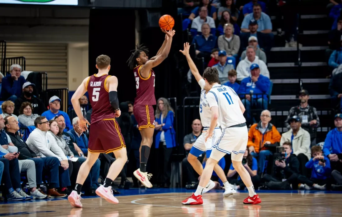 Fourth-year forward Xavier Amos shoots a corner three versus Saint Louis. (Courtesy of Loyola Athletics)