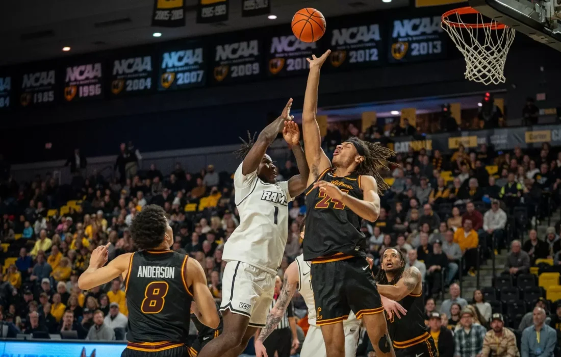 Third-year center Miles Rubin goes for a block against VCU. (Courtesy of Loyola Athletics)